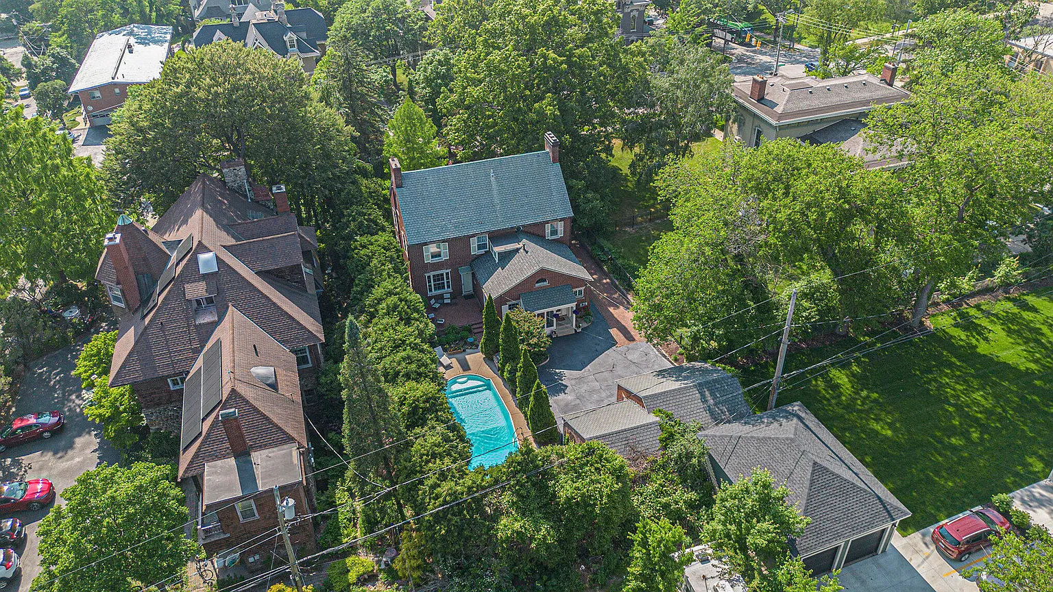 Top down aerial of a brick colonial and its pool, from an EZ Shots shoot