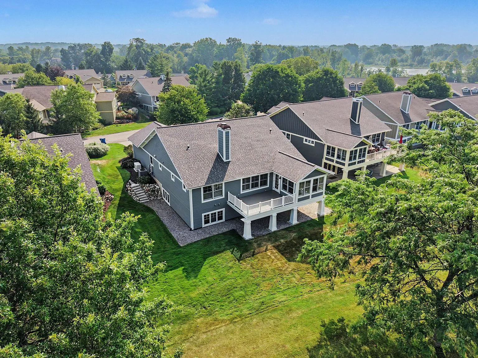 Aerial of a ranch home backing onto a golf course, from an EZ Shots shoot